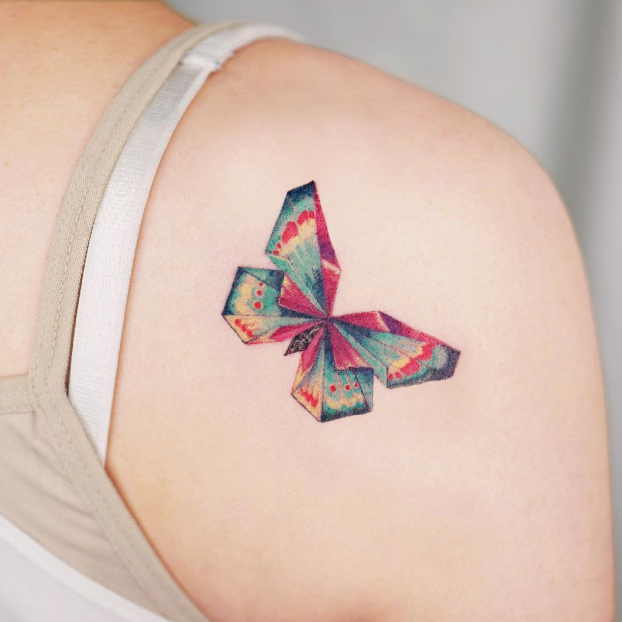 tatuagem de borboleta colorida geométrica